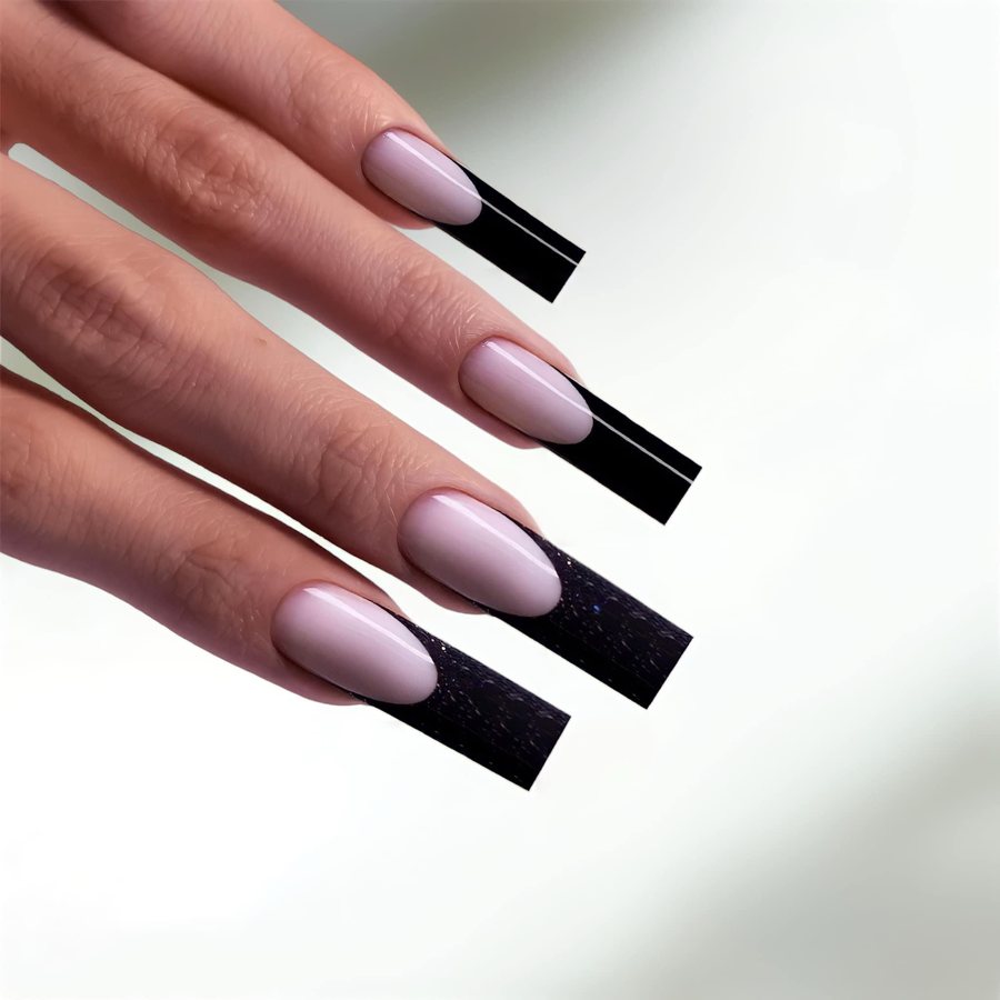 Square nails with soft pink base and black French tips, two with glitter